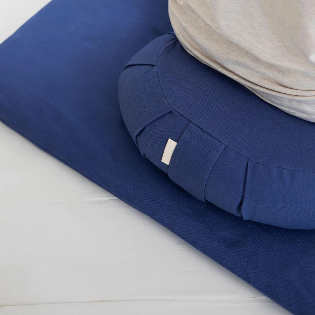 Blue EcoCalm meditation cushion in use during a meditation session