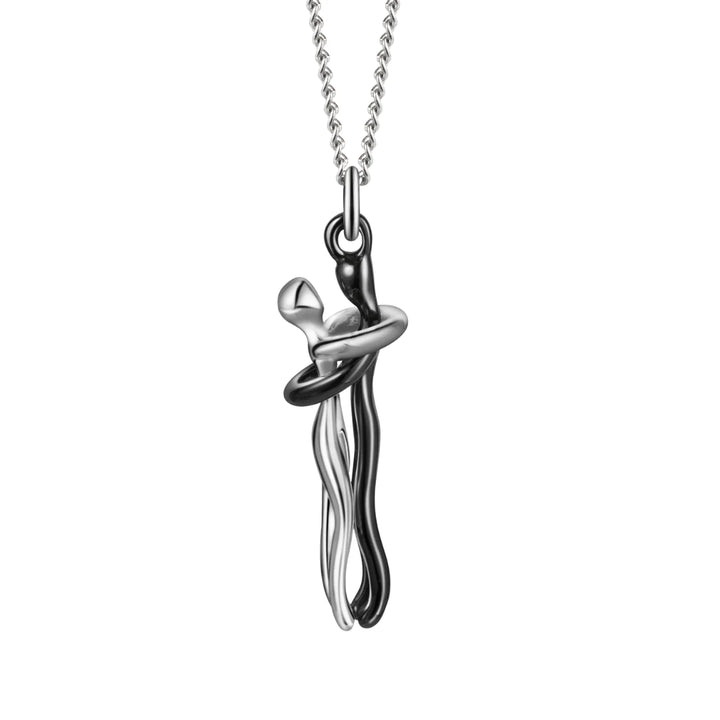Silver couples hugging pendant necklace displayed on a minimalist bust