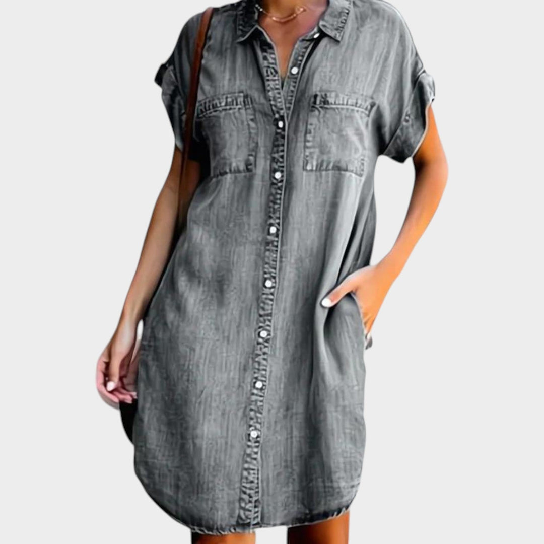 Woman wearing grey mini denim shirt dress with collar and button front