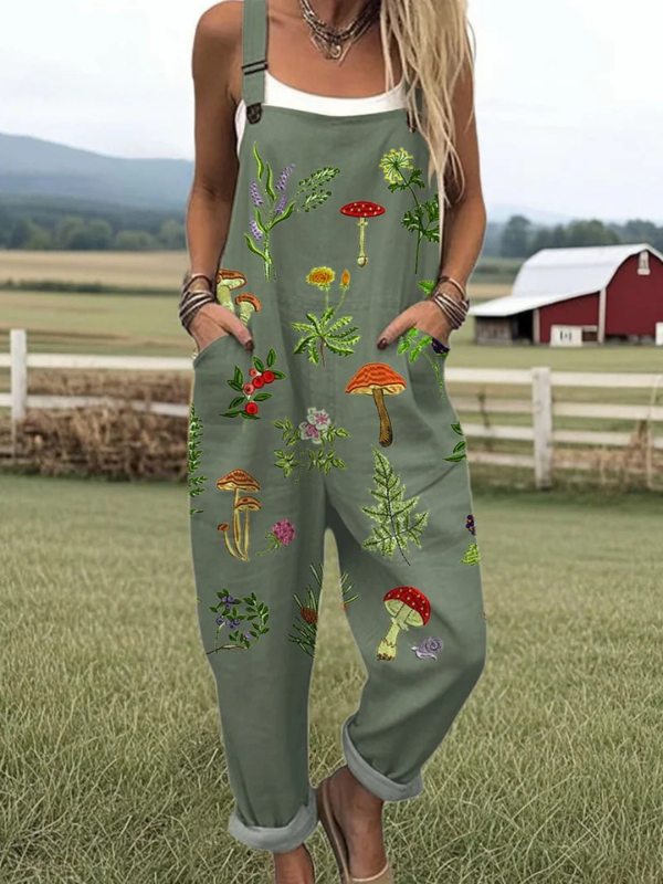 Women wearing a dark green botanical embroidered jumpsuit outdoors