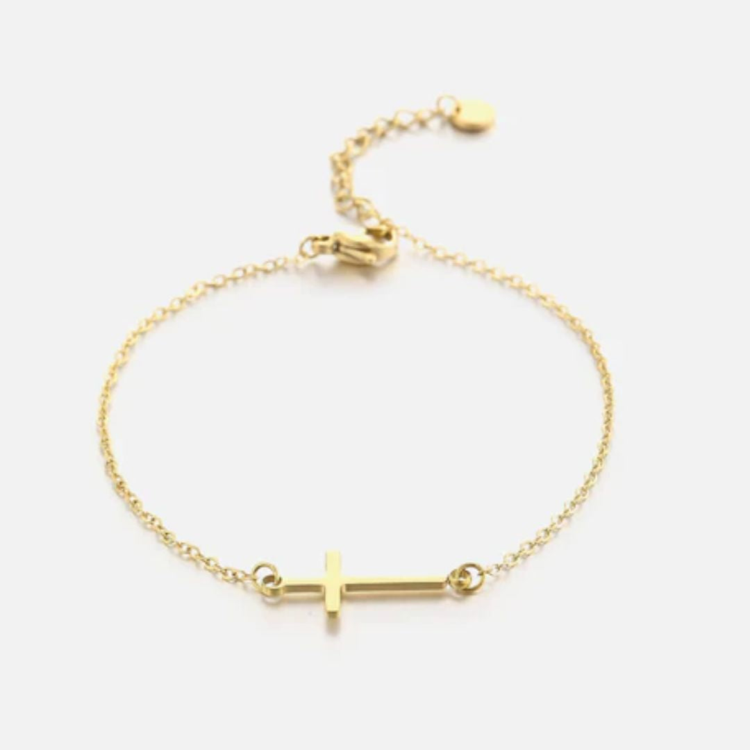 Gold cross bracelet featuring a delicate chain and polished cross pendant
