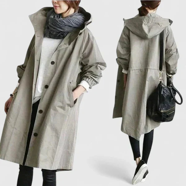 Womens oversized hooded raincoat front view showing waterproof jacket design