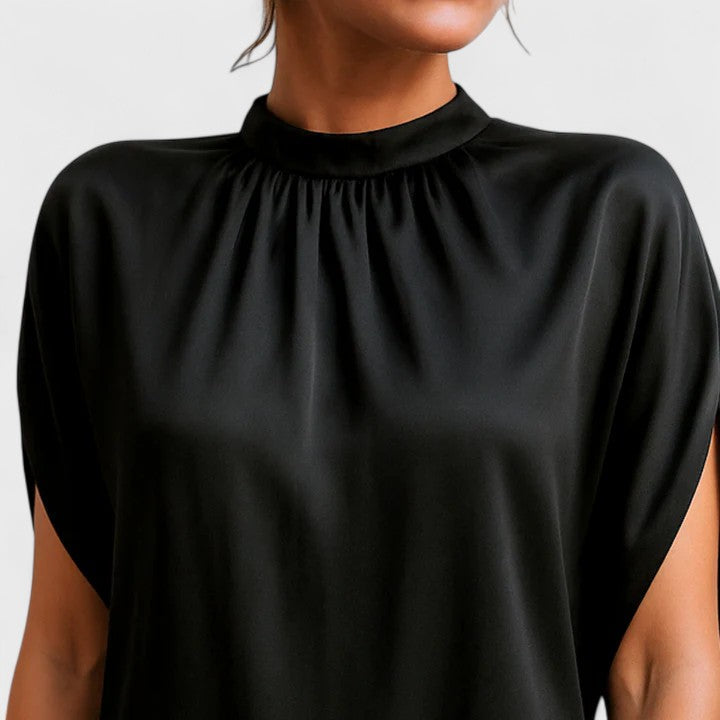 Back view of black mock neck midi dress with batwing sleeves and elegant evening wear silhouette.