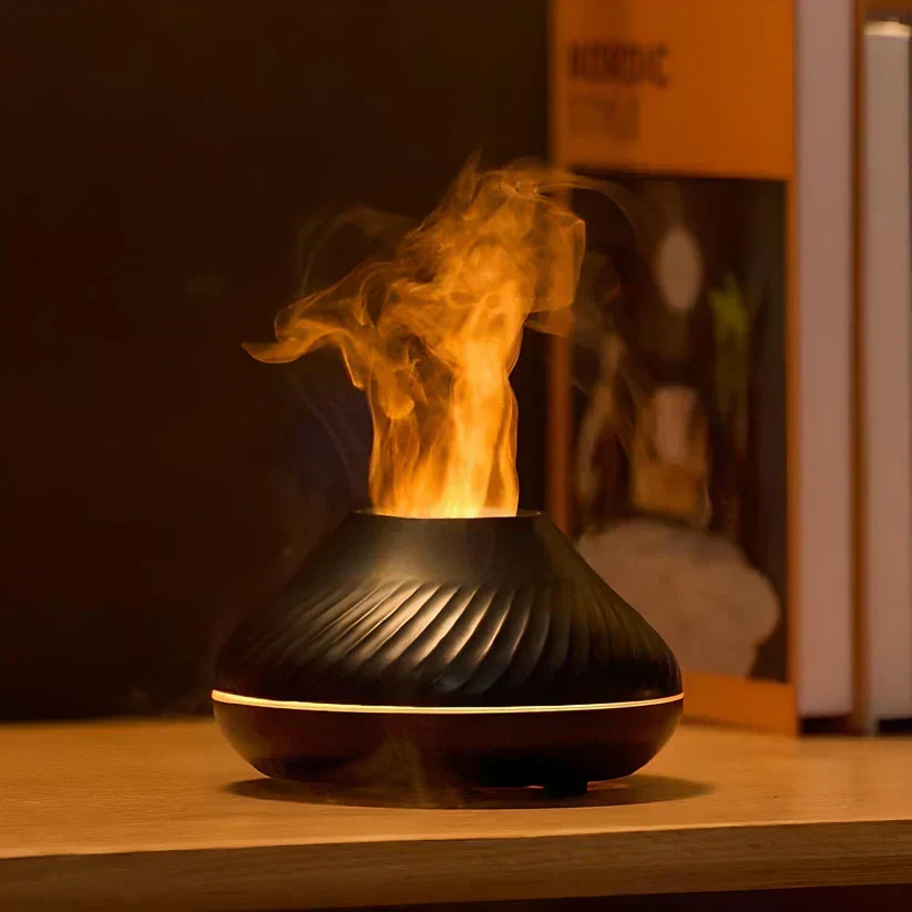 Black LumoMist aroma diffuser glowing with a realistic flame effect