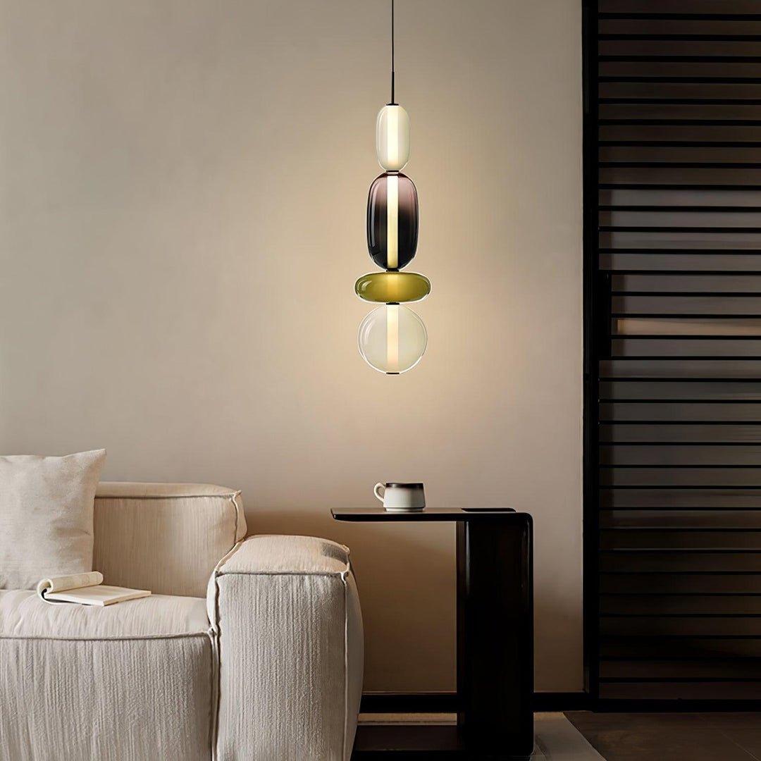 Modern colorful glass pendant light hanging in a contemporary dining room setup