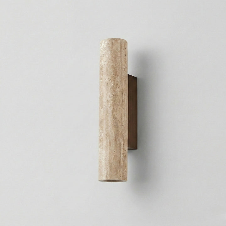 Close-up view of the beige travertine cylinder wall fixture