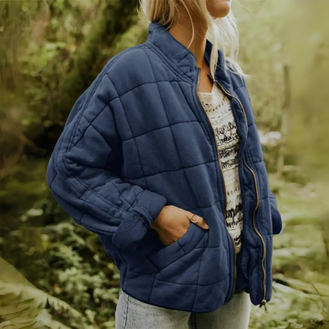 Woman wearing blue oversized quilted puffer winter jacket showcasing casual fit