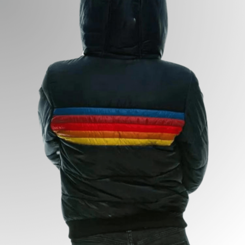 Back view of a woman wearing a dark blue winter puffer jacket featuring colourful retro rainbow stripes across the back.
