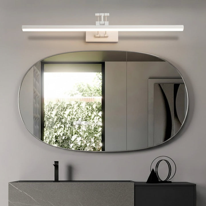 White adjustable LED wall sconce mounted above an oval bathroom mirror