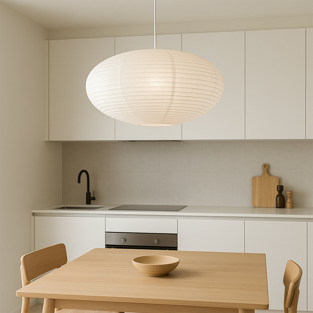 Hanging paper lantern pendant light installed above a kitchen dining space with warm ambient glow.