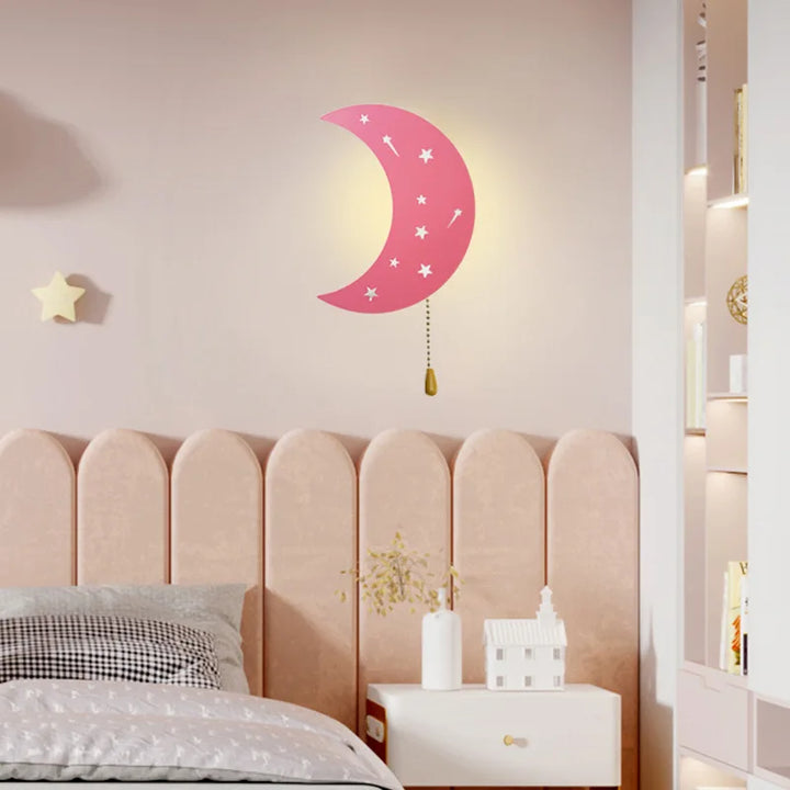 Pink moon wall lamp decorated with white stars mounted on bedroom wall