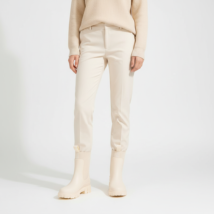 Full view of cream waterproof boots paired with light trousers