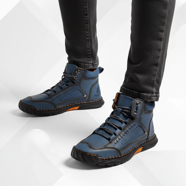 Side view of blue men's ankle boots against a clean studio background