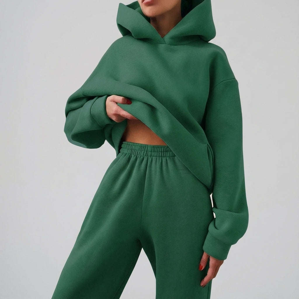 Model wearing complete women's relaxed fit tracksuit and sneakers
