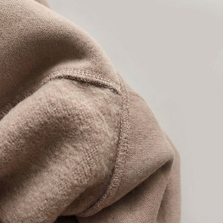 Detailed view of the soft interior fleece texture and robust stitching of the tracksuit