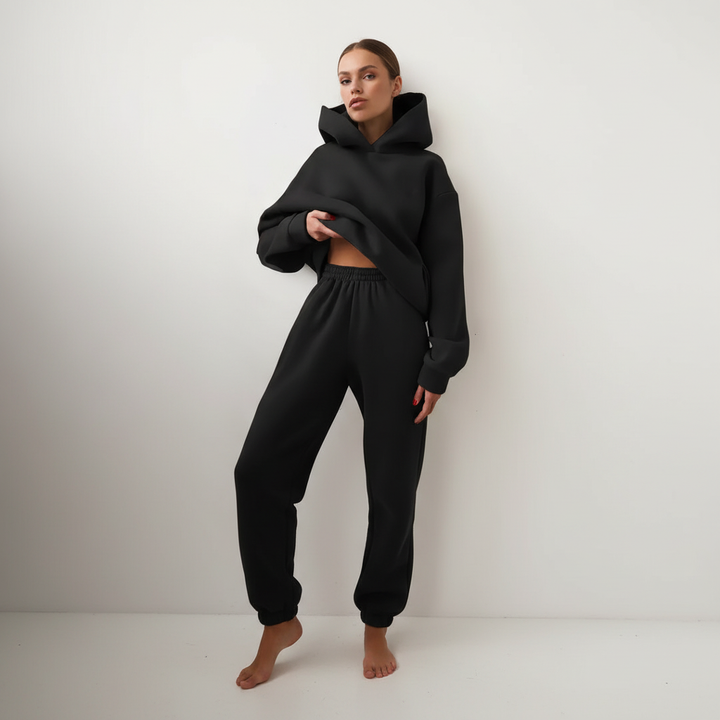 Angled view of the soft fleece hoodie paired with comfortable lounge bottoms