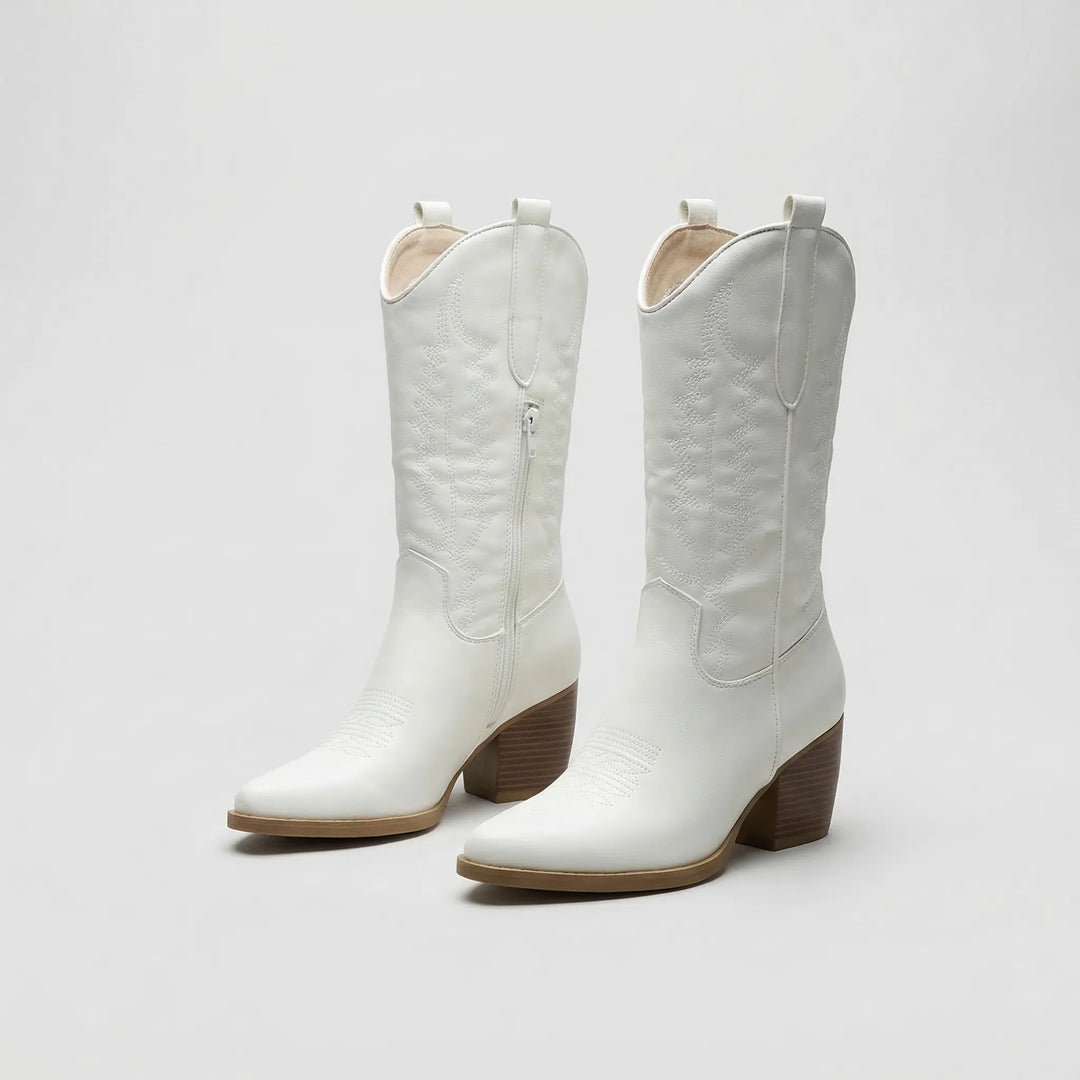 Side view of knee high western boots with comfortable block heel and pointed toe