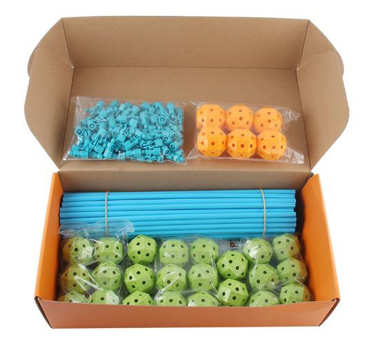 Open box showing organized construction rods and connecting balls