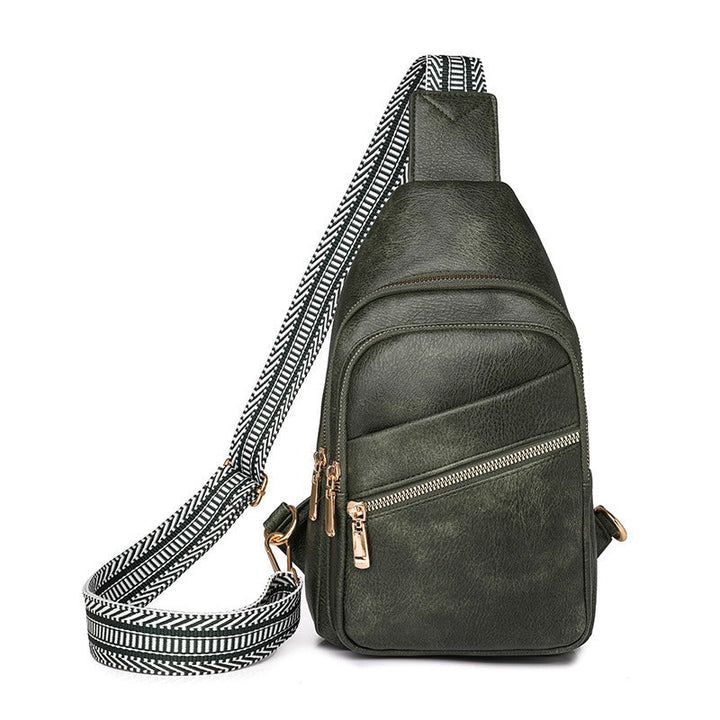 Women's modern everyday sling bag in black with patterned strap