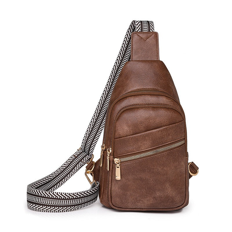 Women's modern everyday sling bag in dark brown with patterned strap