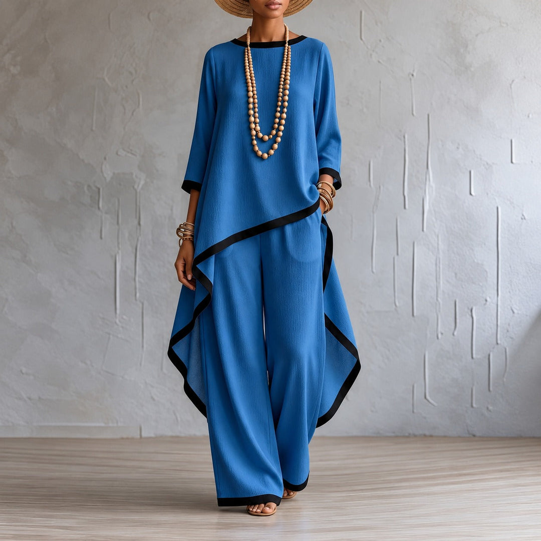 Close up fabric detail of stylish asymmetric top and wide-leg trousers outfit