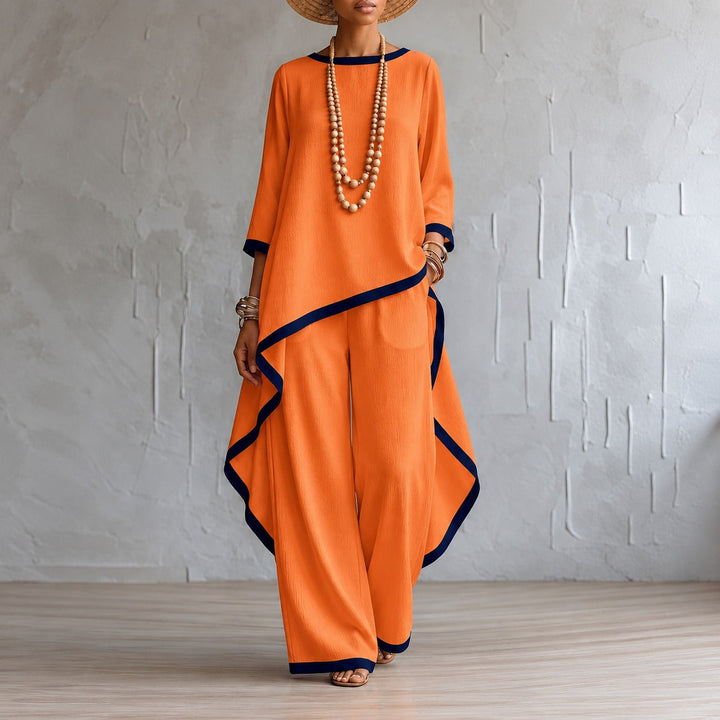 Model wearing trendy women's set with asymmetric hem top and flowing pants
