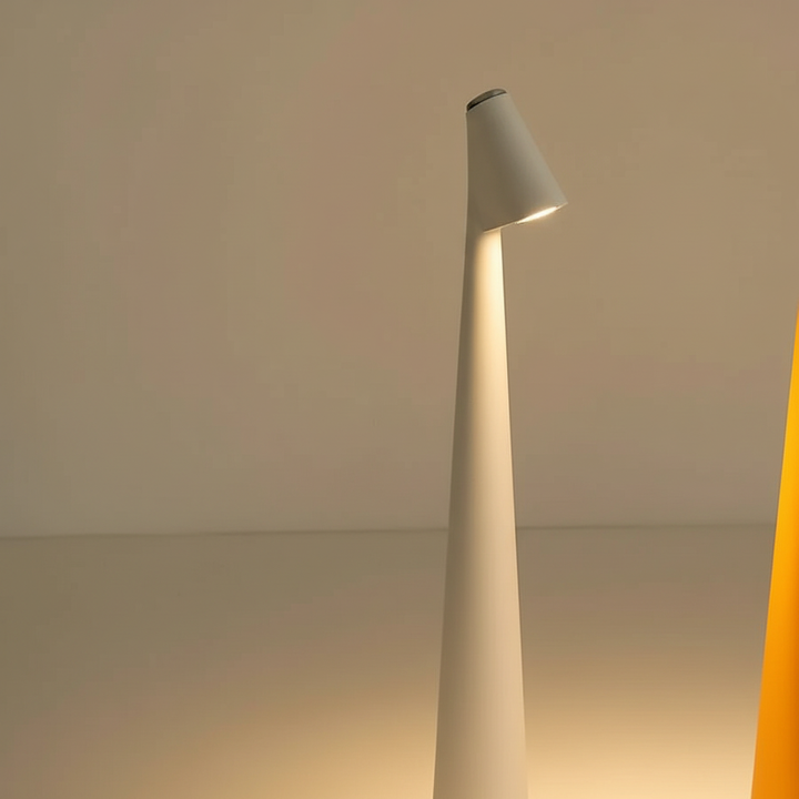 Close up view of the slim silhouette and warm top illumination of the minimalist table lamp