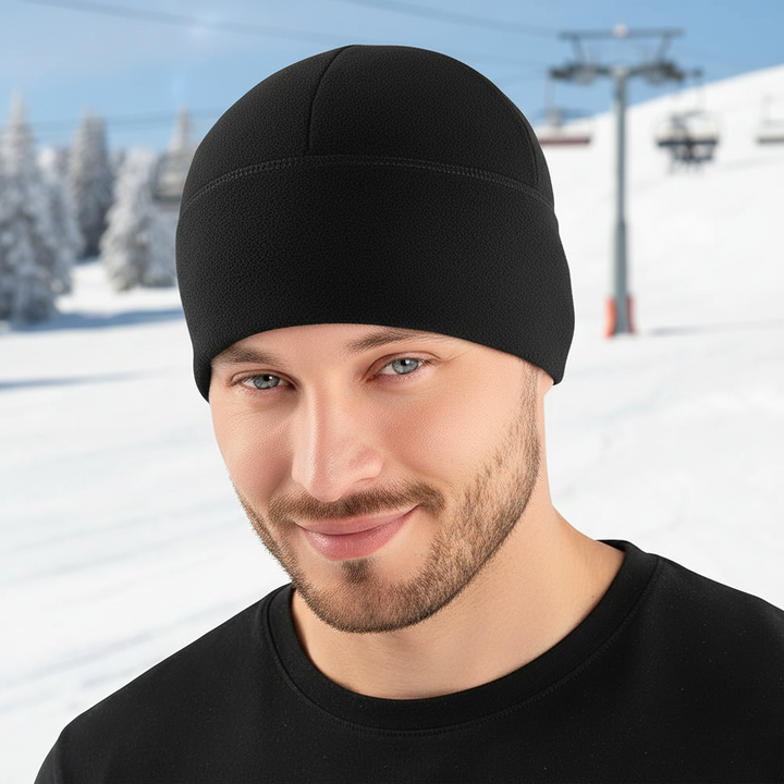 Close-up portrait of a man wearing a black thermal winter beanie hat