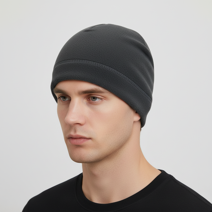 Thermal cap for cold weather worn by a model, featuring a snug fit