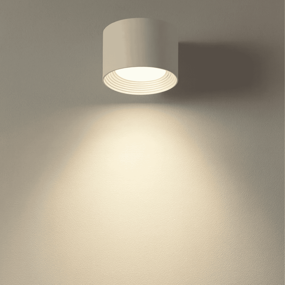 Minimalist wireless LED wall sconce installed in a modern living room
