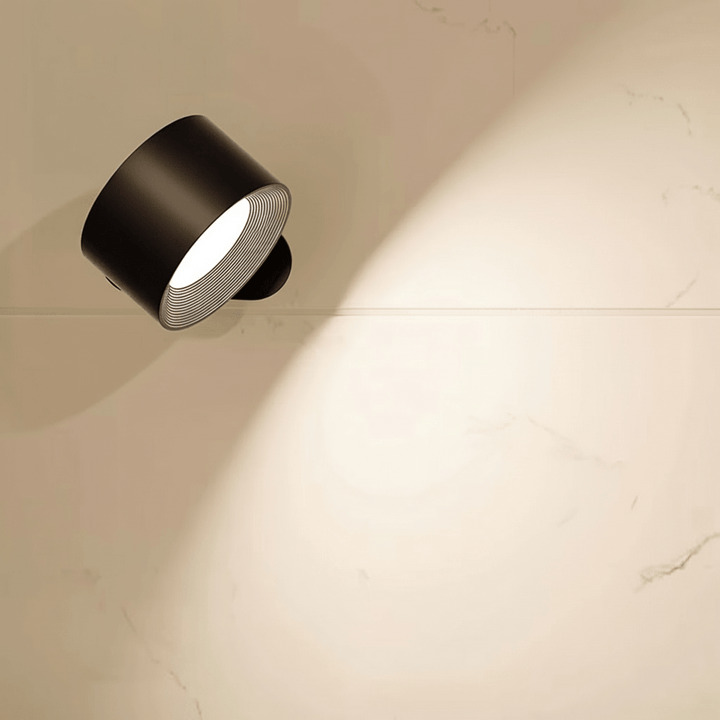 Modern wireless wall sconce with remote control resting on a wooden surface