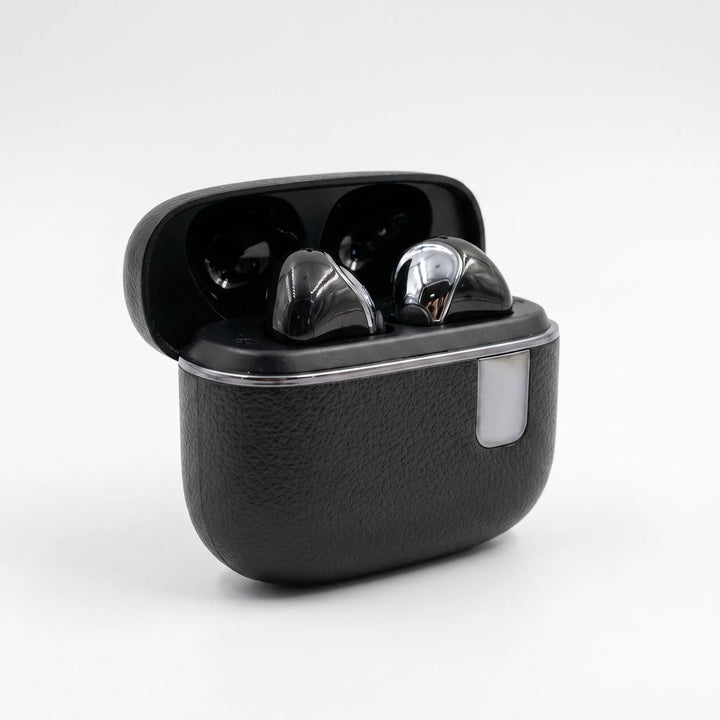 Closed black charging case for wireless earbuds on neutral background