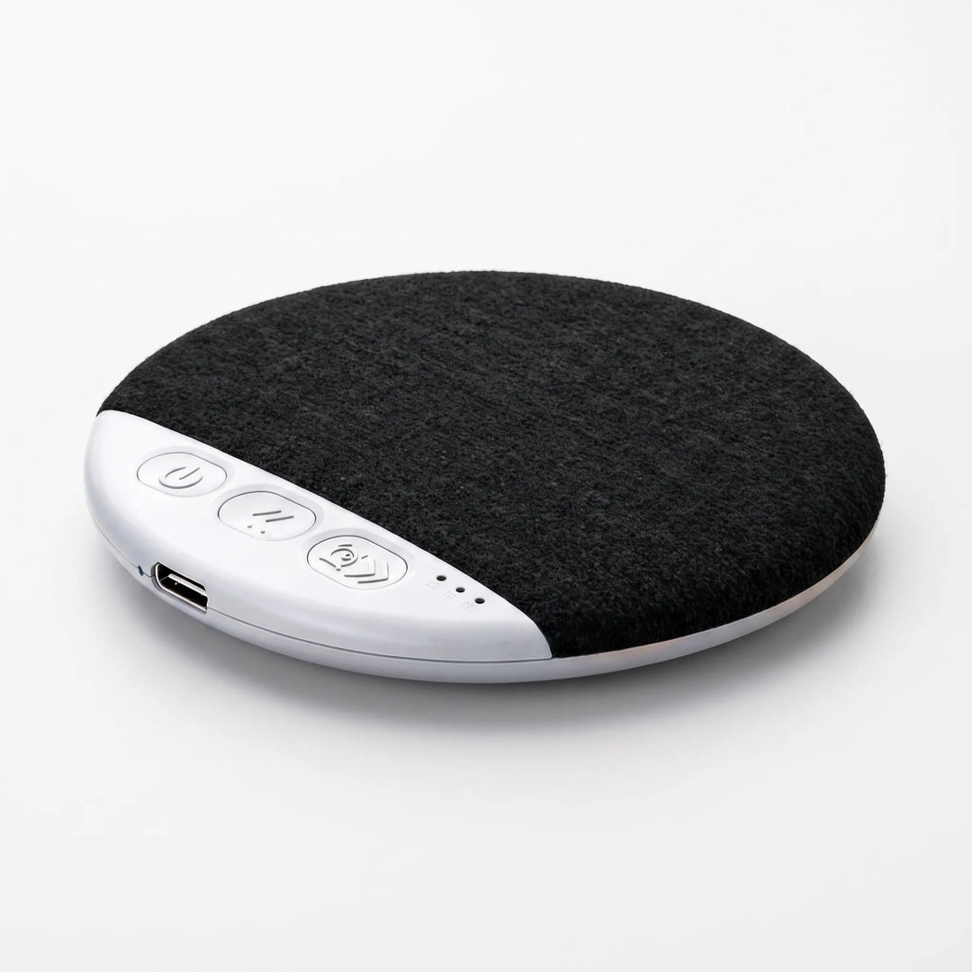 Close-up angled view of the black wireless pillow speaker showing control buttons