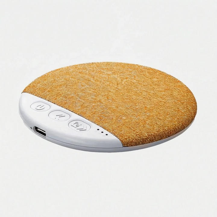 Thin wireless speaker playing white noise under a fluffy pillow