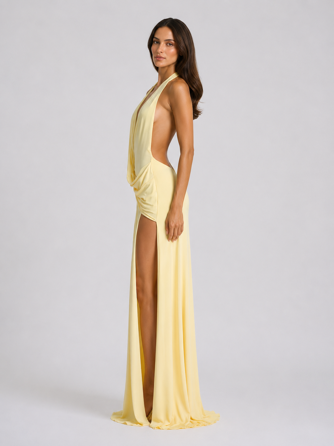 Back view of a yellow halterneck evening maxi dress showing the open back design.
