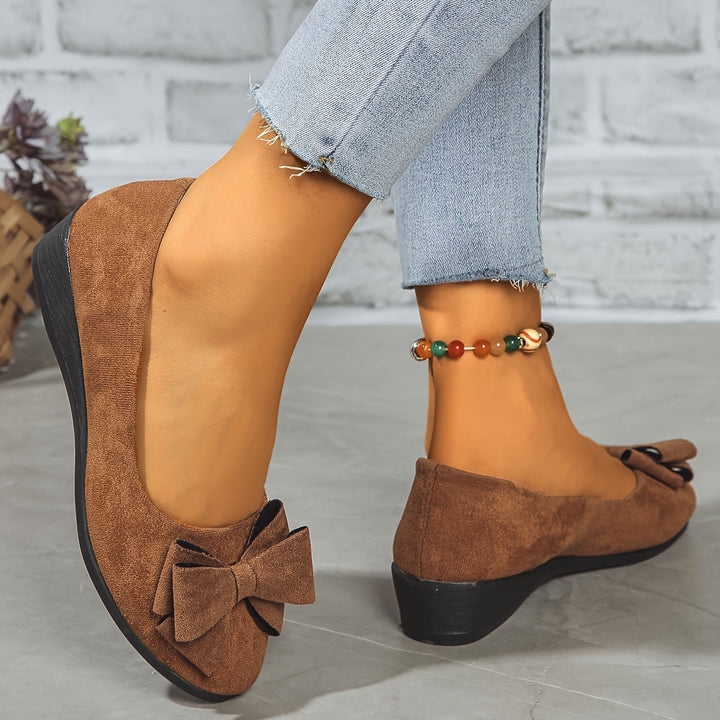 In-use lifestyle view of woman wearing casual bow-detail orthopedic flats