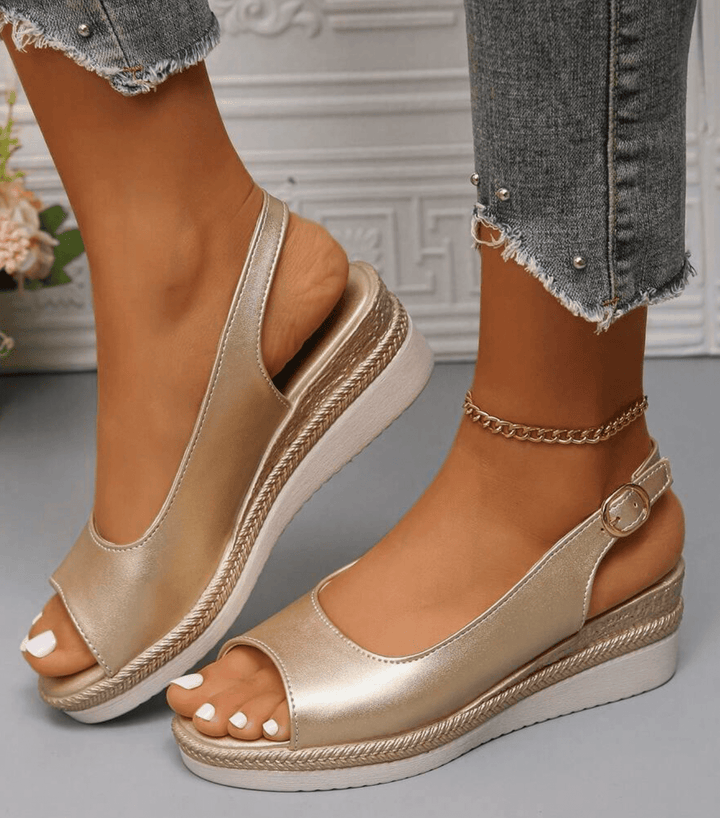 Side profile of a woman showcasing comfortable gold wedge sandals with ankle strap