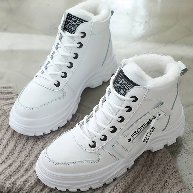 Pair of white waterproof snow boots with decorative side zipper detail