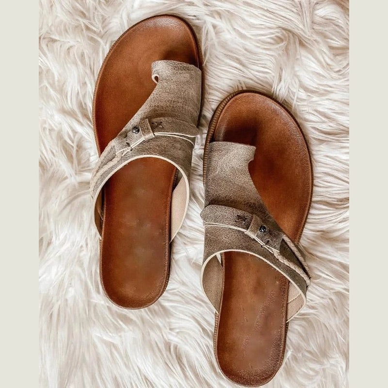 Top down view of beige toe loop summer slide sandals