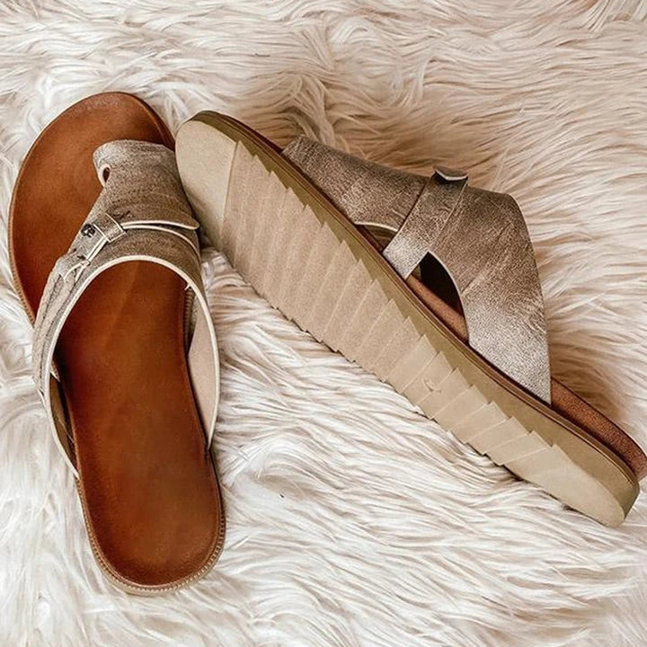 Side profile view of beige summer sandals showing textured sole