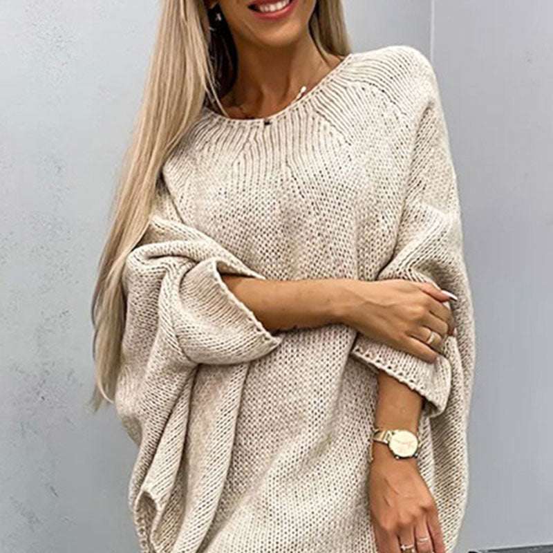Woman wearing beige oversized batwing sleeve knit sweater
