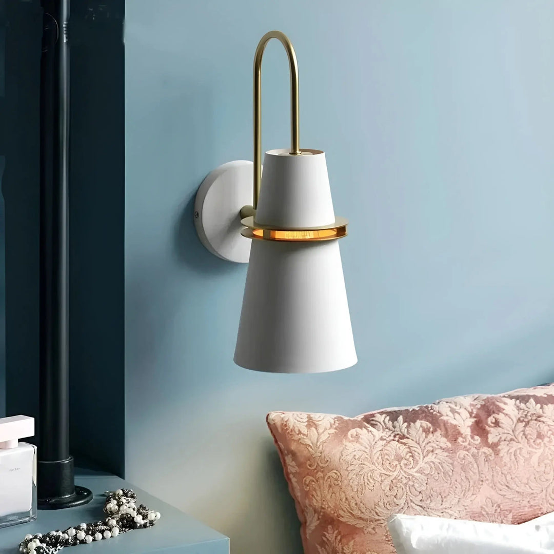 Contemporary horn sconce wall lamp illuminated in a cozy living room setting