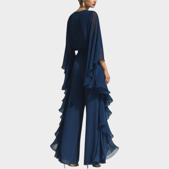 Back view of women's flowing navy blue formal matching set