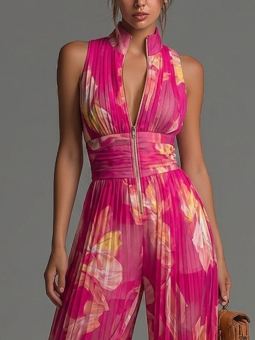 Front close-up view of a woman wearing a fuchsia floral pleated wide-leg jumpsuit with a deep V-neckline.