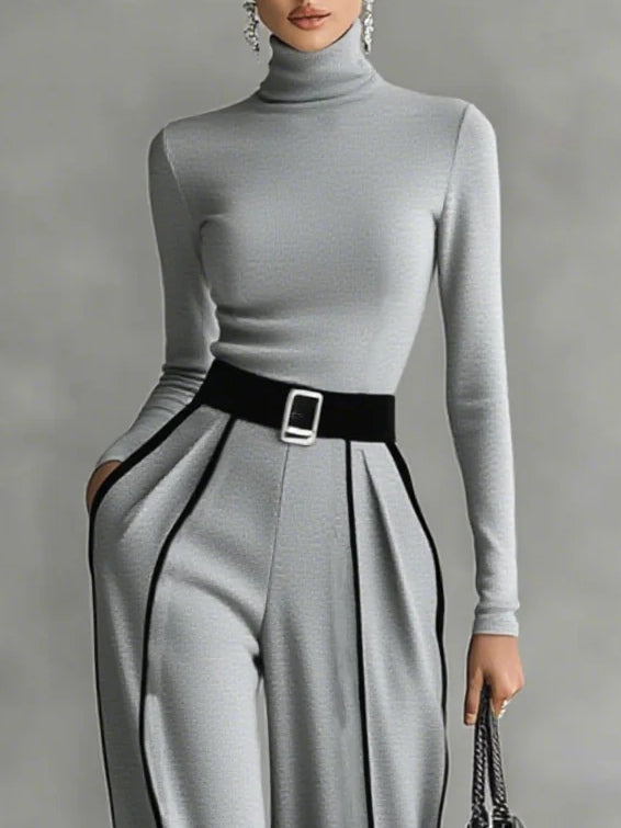 Close-up view of the gray high-neck top and structured wide-leg trousers