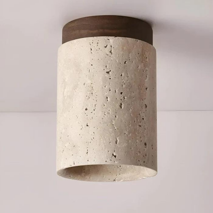 Ambient home lighting LED fixture emitting soft glow from travertine base