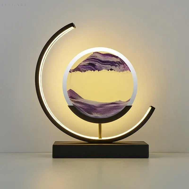 Purple and white moving sand art table lamp glowing on a white surface