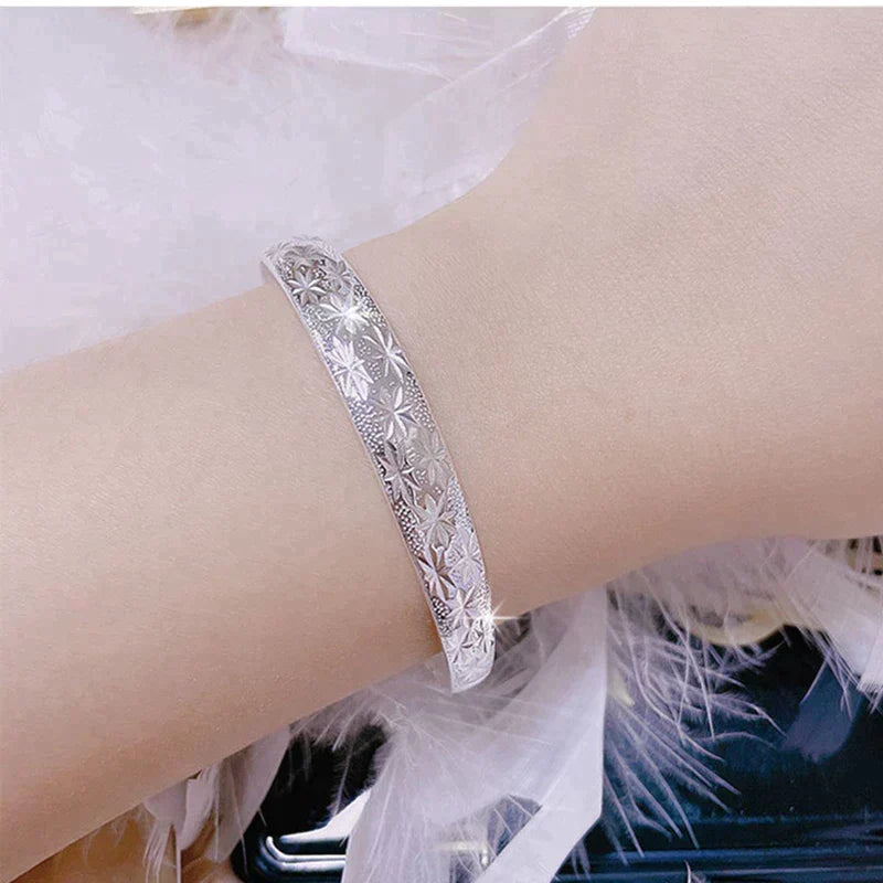 Adjustable silver star bracelet displayed elegantly on a neutral background, ideal gift for her