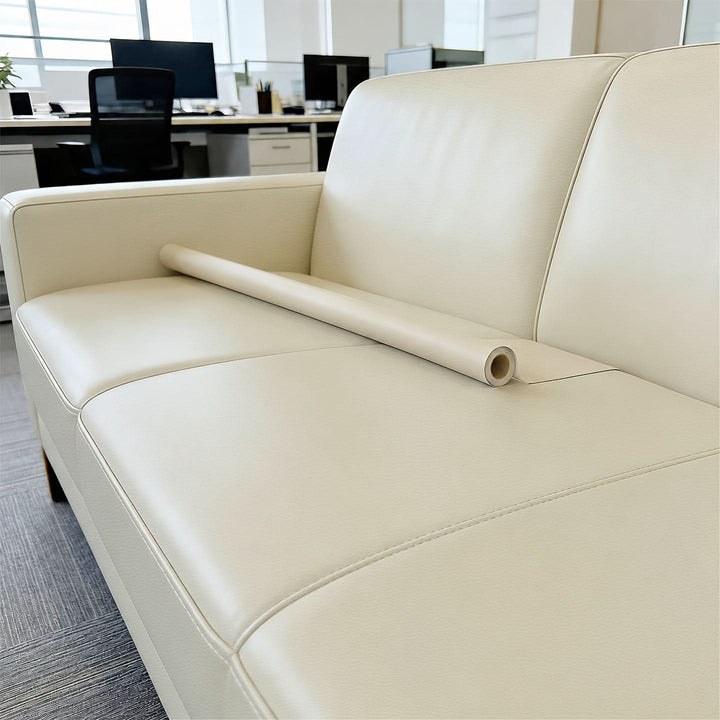 Brown leather repair tape blending seamlessly with wooden armchair