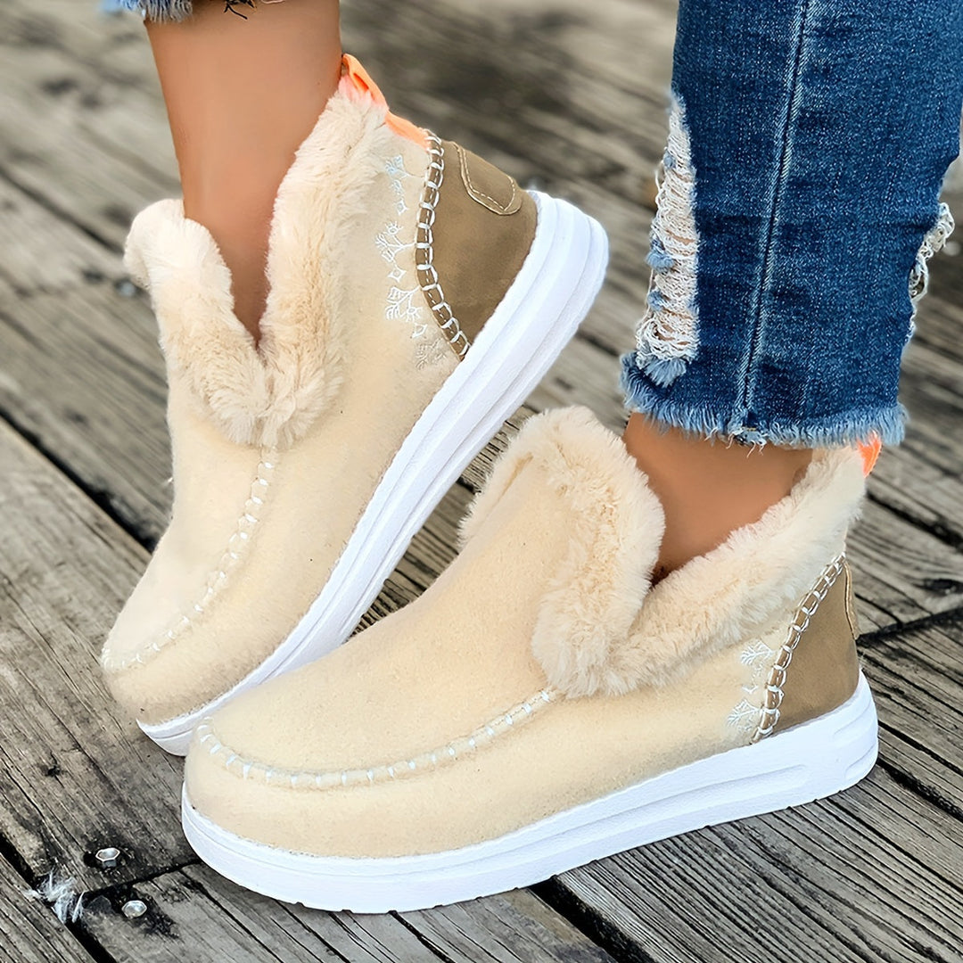 Close-up of beige warm winter slippers showcasing soft plush interior